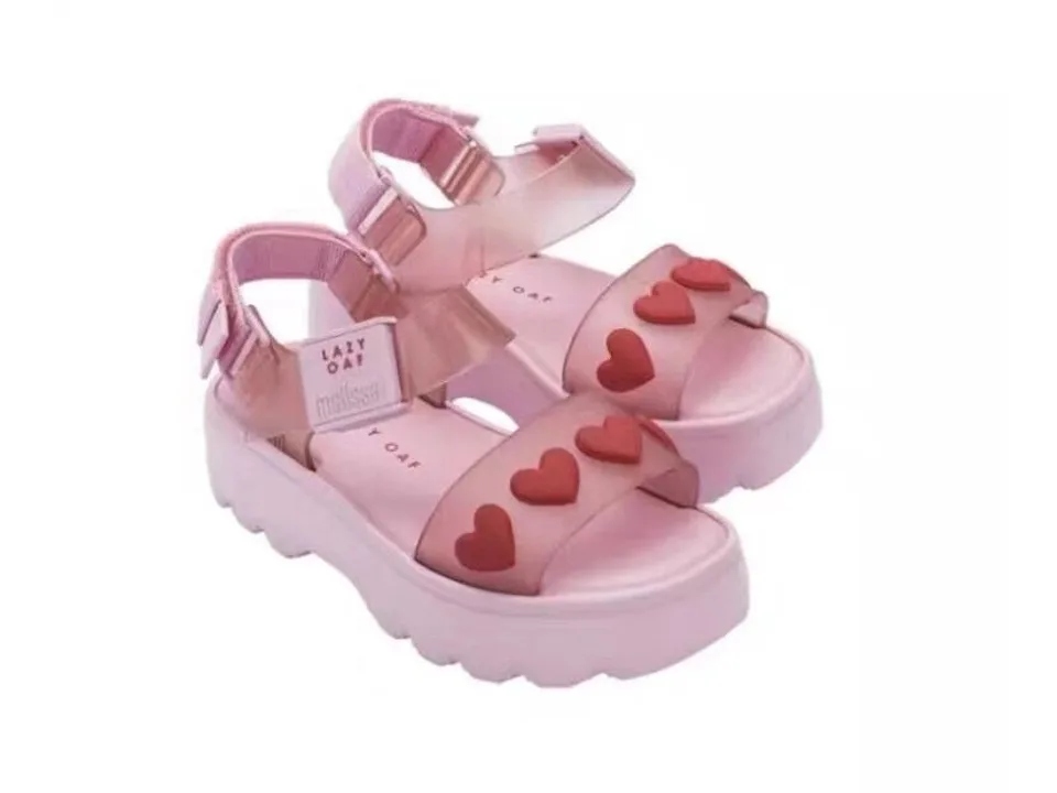 Pink platform sandals with red heart embellishments on the strap.