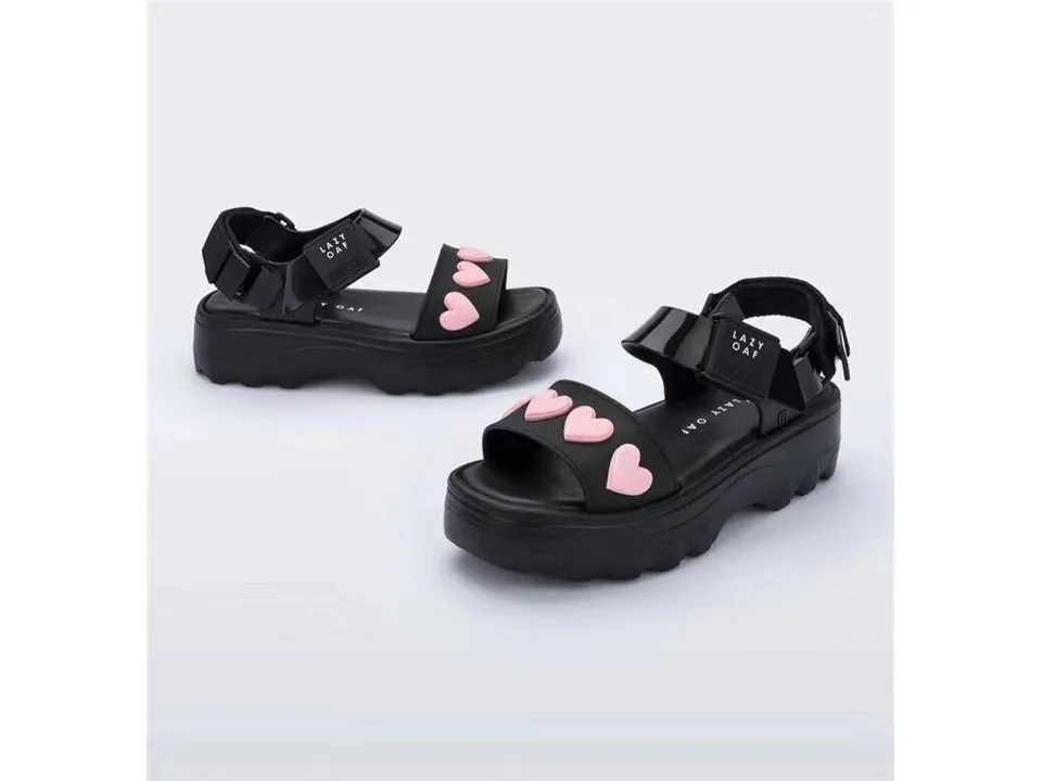 Black platform sandals with pink heart embellishments on the strap.