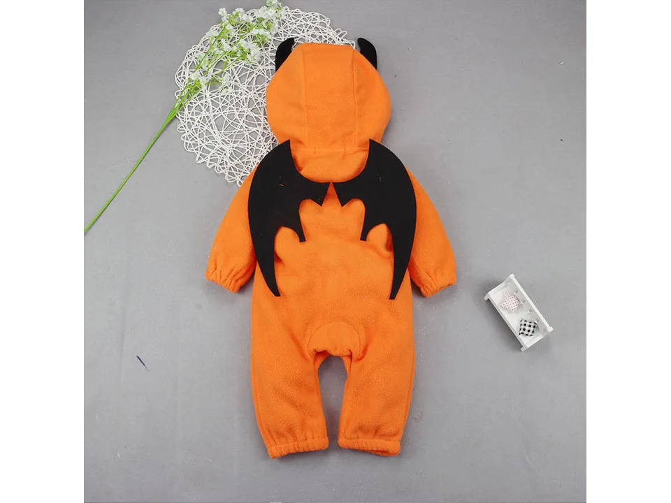 Full view of an orange baby jumpsuit with a hood and black bat wings on the back.