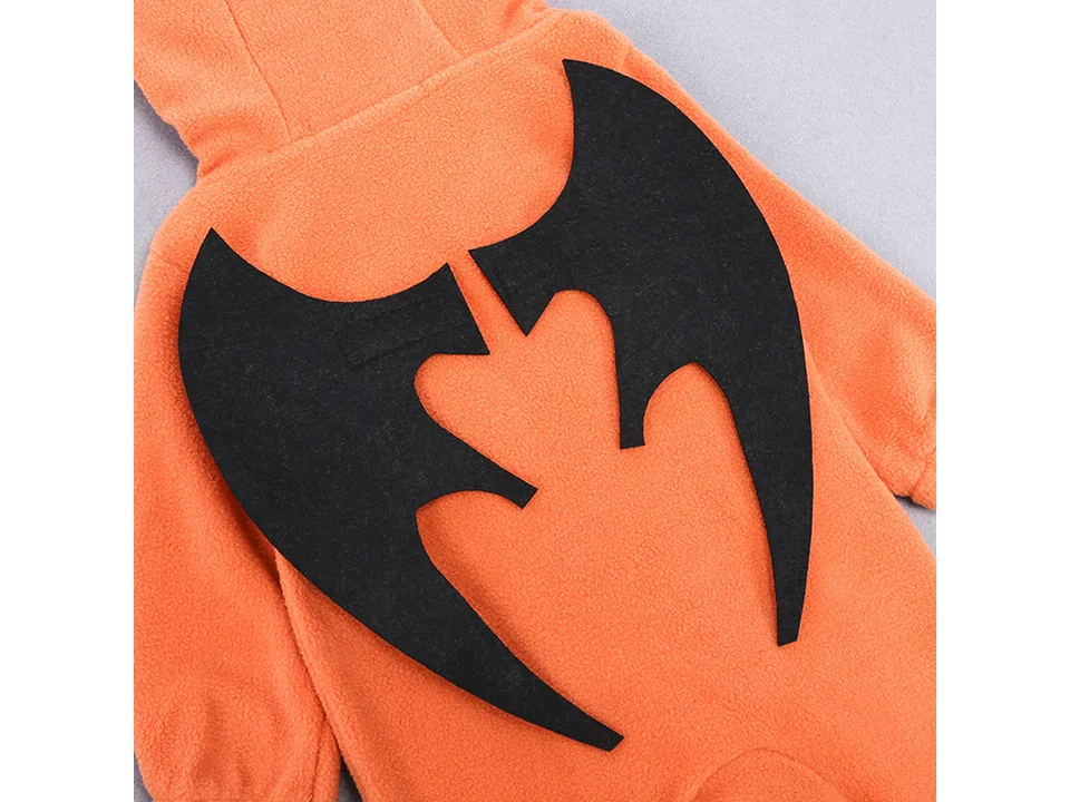 Close-up of black felt bat wings attached to the back of an orange fleece baby jumpsuit.