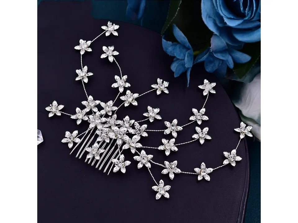 A detailed view of a silver rhinestone flower hair comb.