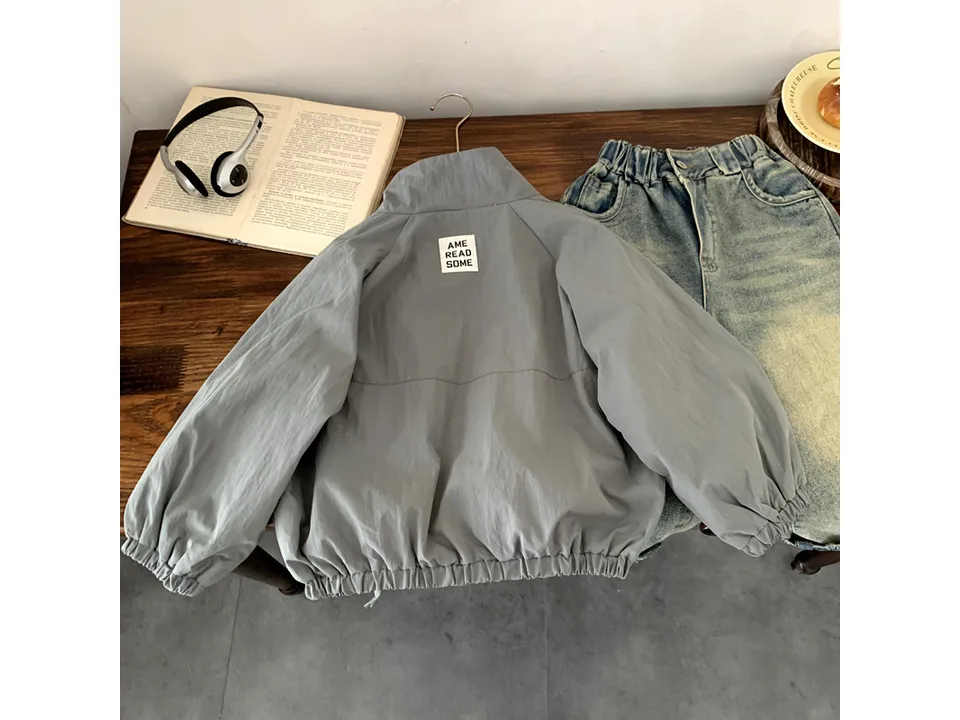 The back of the grey jacket showing a small label detail.