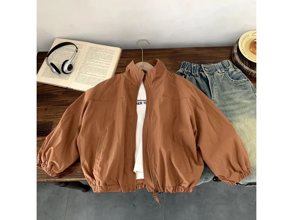 A brown zip-up jacket laid flat on a wooden surface.