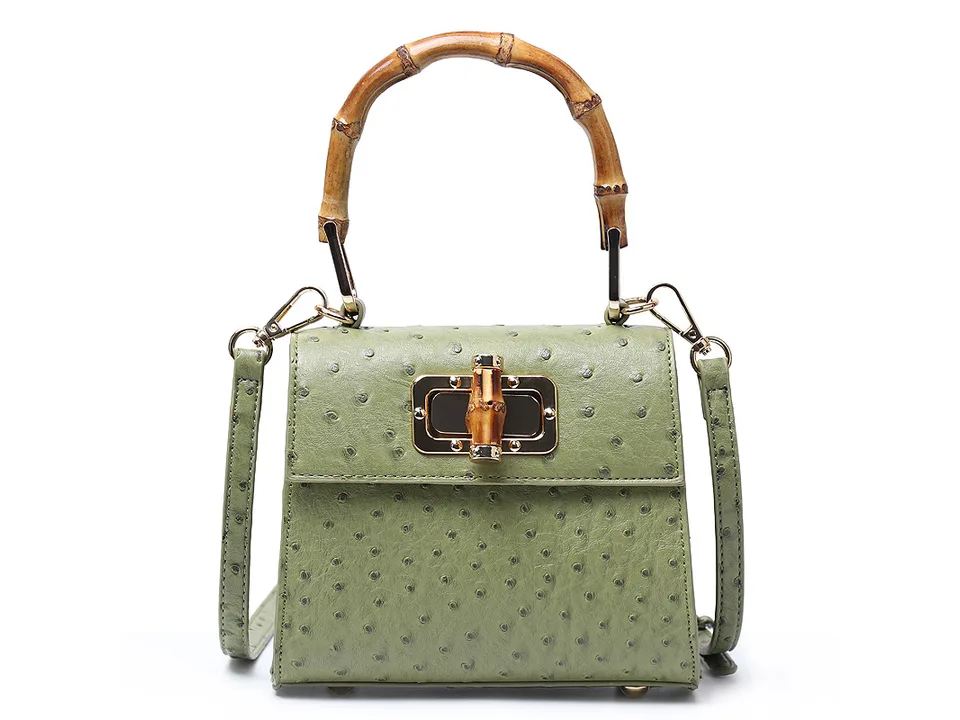 Green trapezoid handbag with bamboo handle and clasp