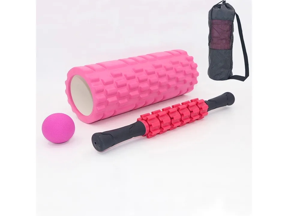 Pink foam roller, massage stick, massage ball, and black carrying bag on a white background.