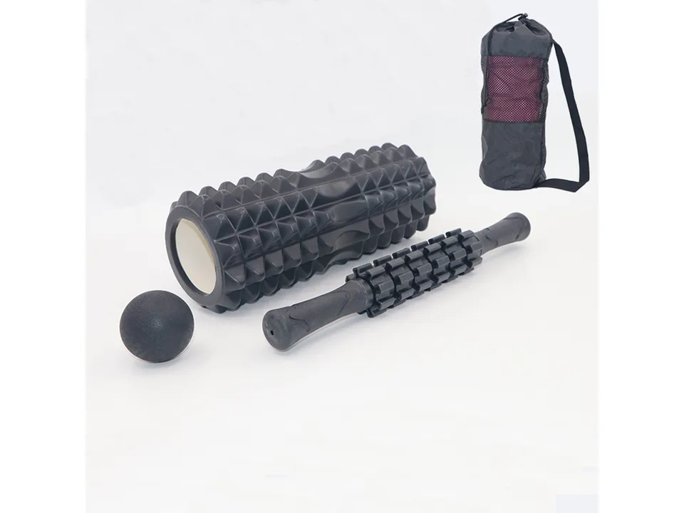 Black foam roller, massage stick, massage ball, and black carrying bag on a white background.