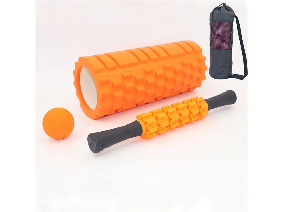 Orange foam roller, massage stick, massage ball, and black carrying bag on a white background.