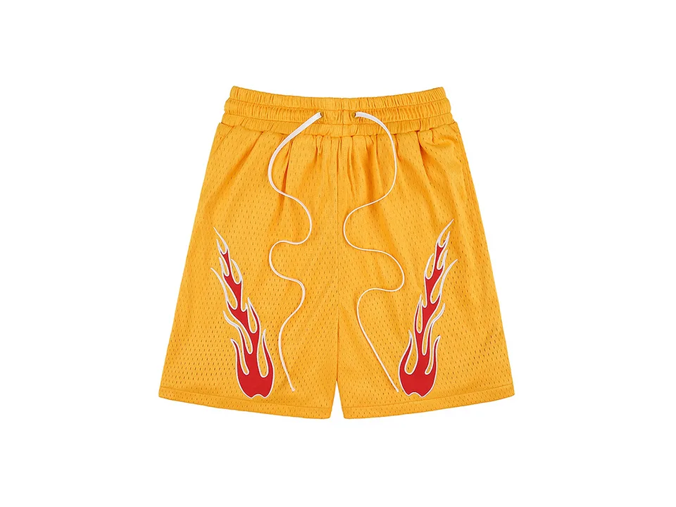 Yellow athletic shorts with red flame embroidery and white drawstring.