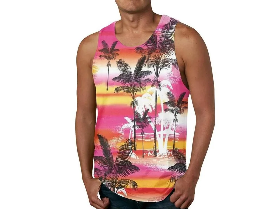 A man wearing a sleeveless tank top with a pink and orange sunset and palm tree graphic print.