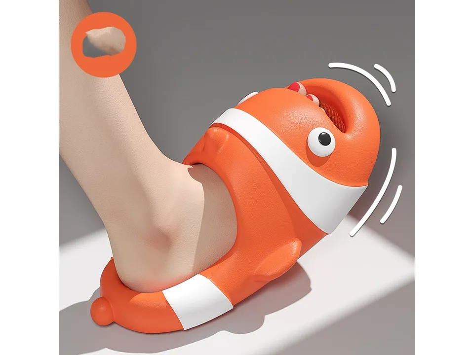 A close-up of a foot wearing an orange clown fish slide, showing the flexible material.