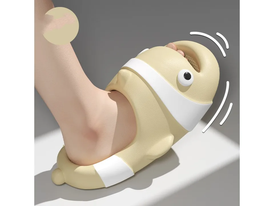 A close-up of a foot wearing a beige clown fish slide, showing the flexible material.