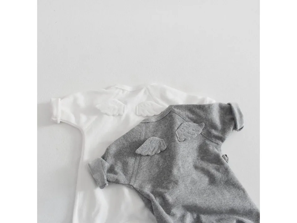 Back view of white and grey baby jumpsuits featuring decorative angel wings.