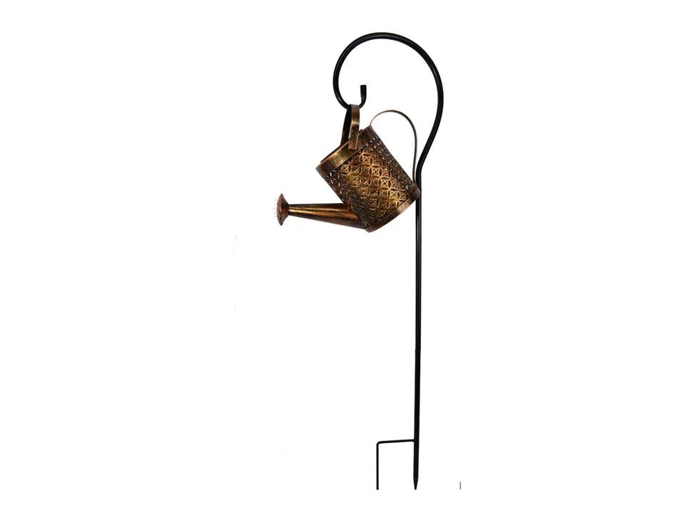 A metal watering can light hanging from a black shepherd's hook.