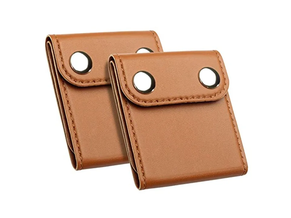 Two brown car seat belt adjuster clips.