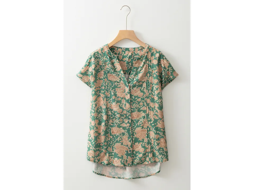 Front view of the green floral button-down shirt on a hanger.