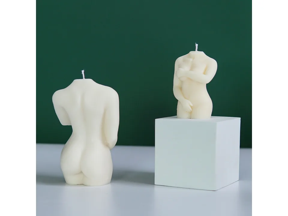 Two finished female torso candles, one viewed from the back and one from the front.
