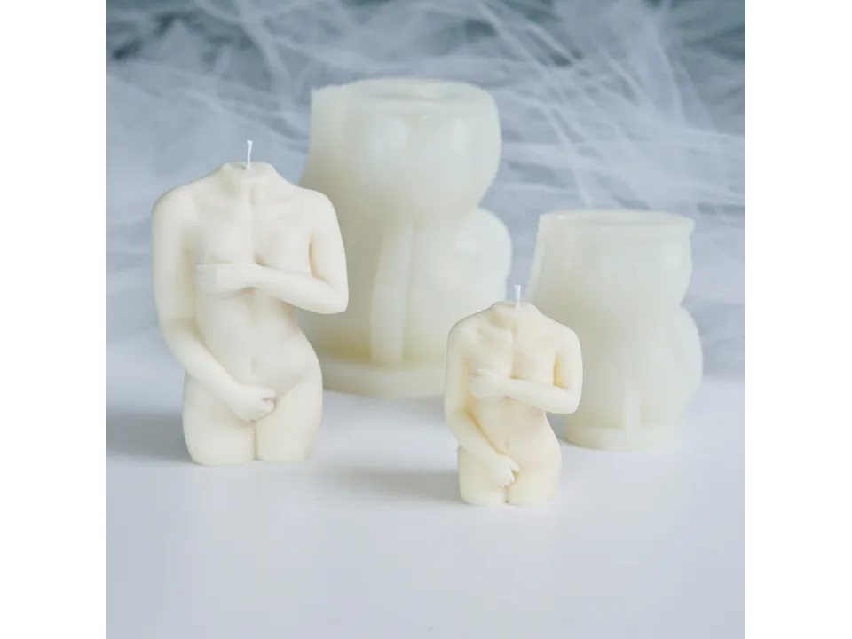 Two different sizes of female torso candle molds and their corresponding finished candles.
