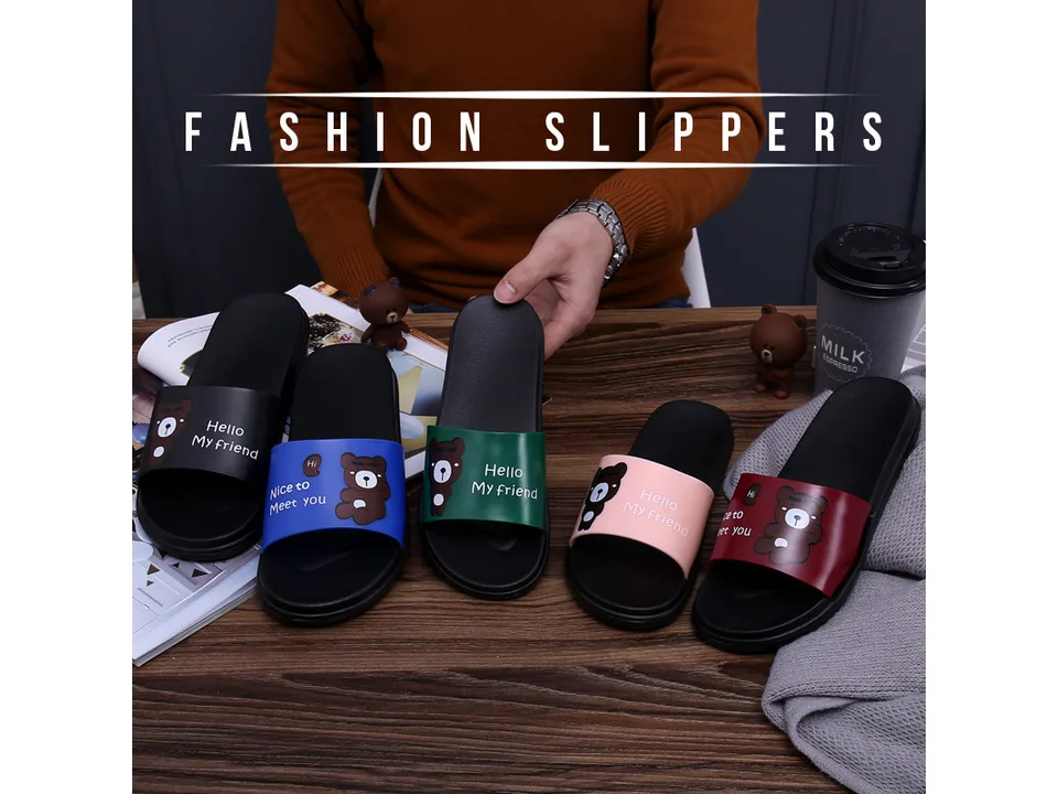 A collection of cartoon bear slippers in various colors displayed on a wooden table.