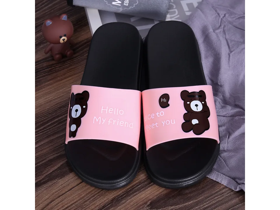 A pair of pink cartoon bear slippers with 'Hello My friend' and 'Nice to Meet you' text.