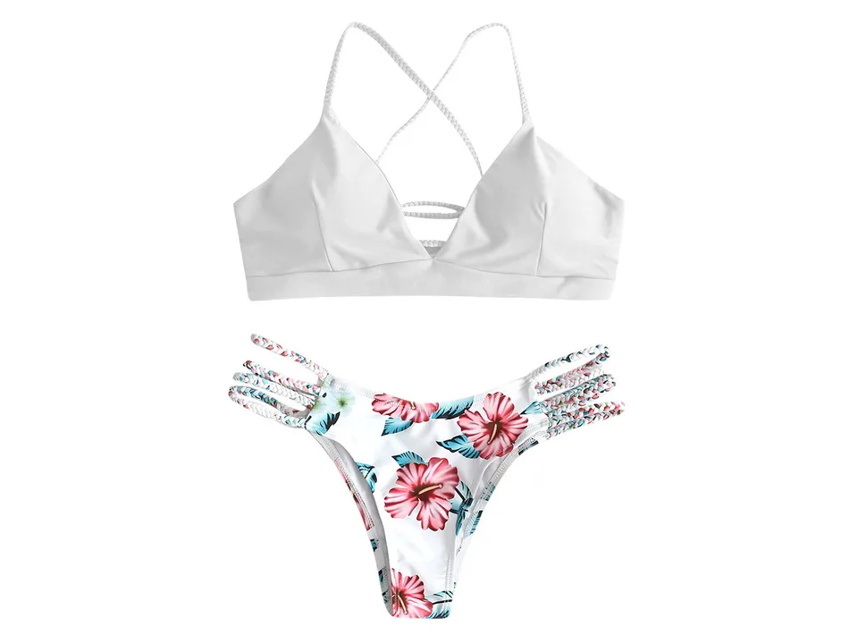 A white bikini top and floral print bottoms with braided straps.