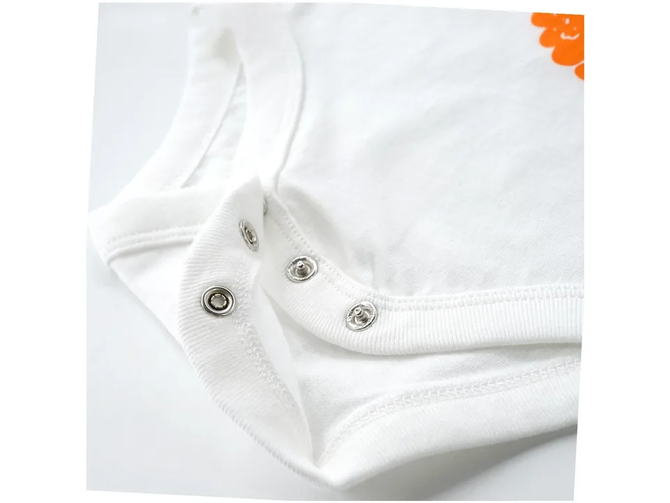 Close-up of the metal snap buttons on the baby romper.