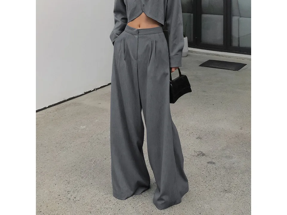 Close-up view of the wide leg trousers on a model.