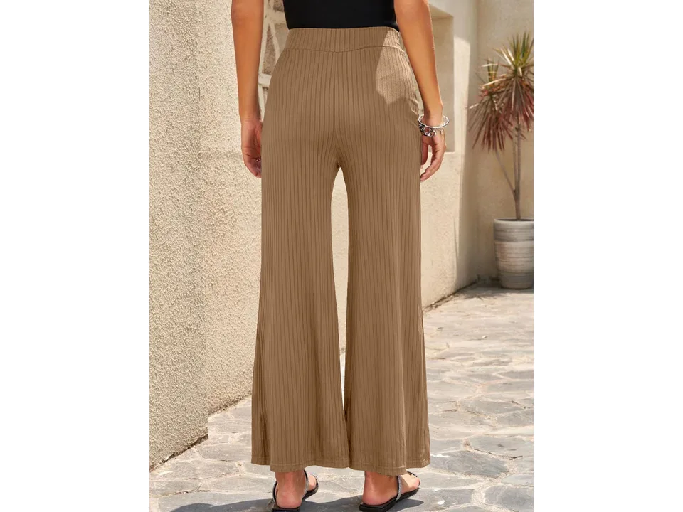 Back view of beige wide-leg ribbed pants on a model.