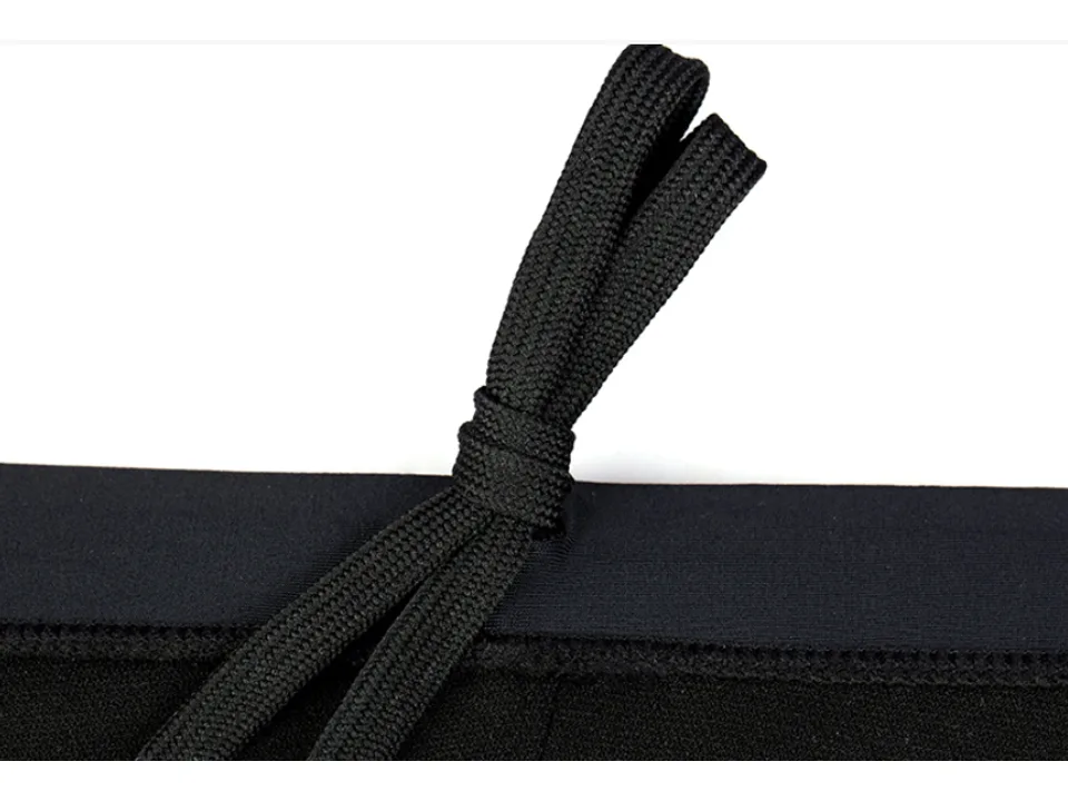 Close-up of the black drawstring on the waistband of the swim trunks.