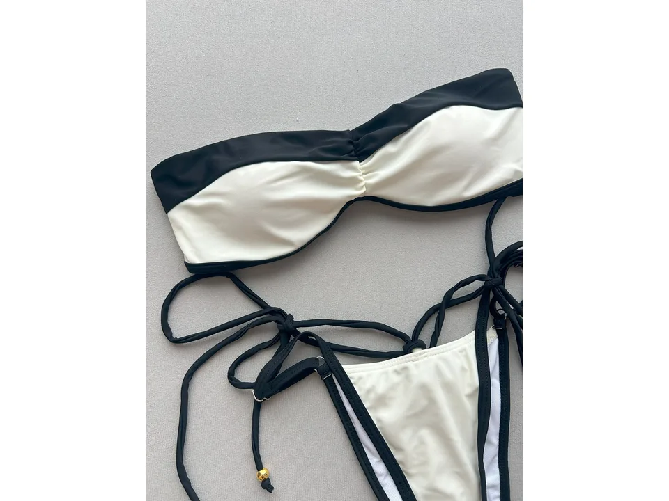 Close-up of the black and white bikini top and side ties.