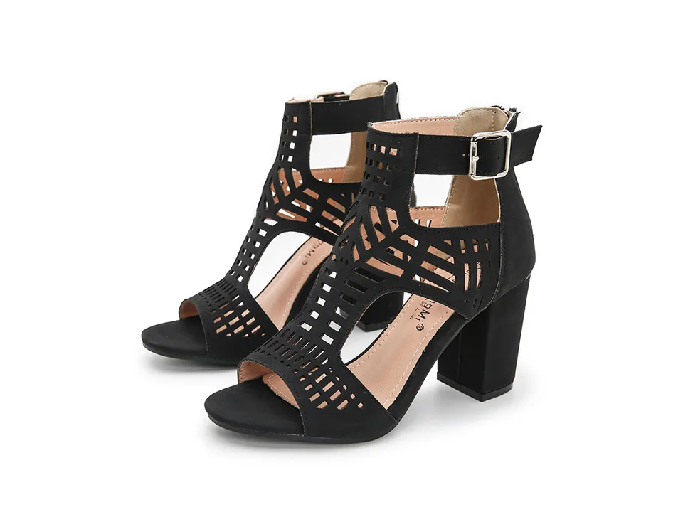 A pair of black cutout high heel sandals.