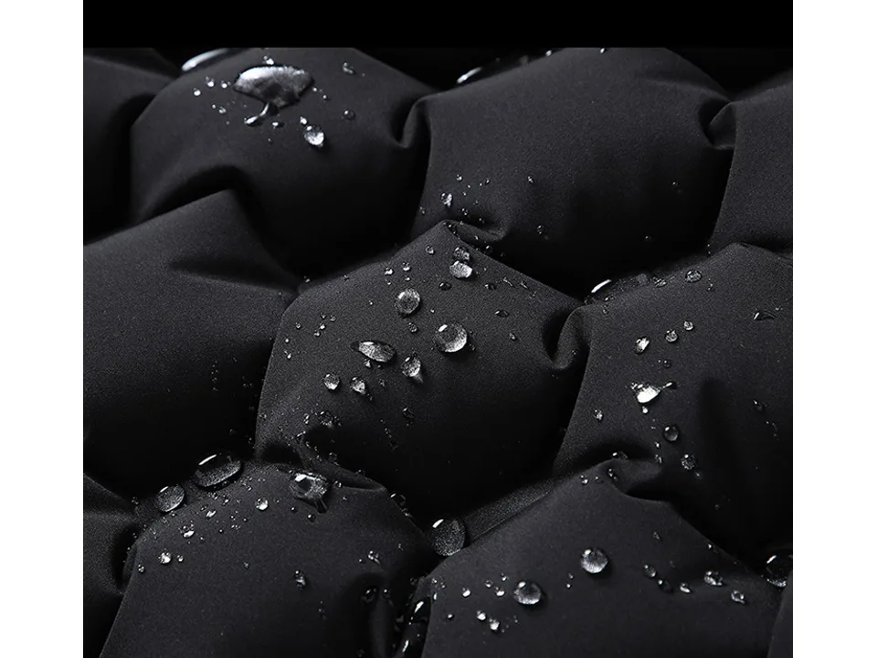 Close-up of the black vest fabric with water droplets on the surface.
