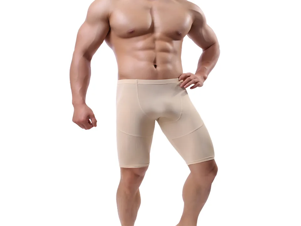 A man wearing beige athletic compression shorts.