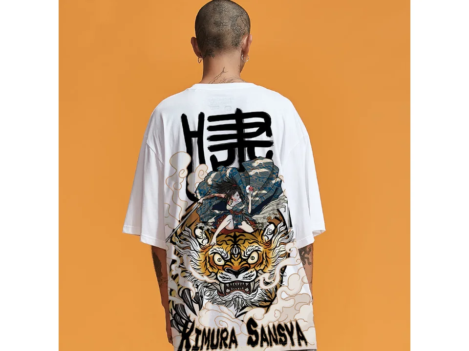 A person wearing a white oversized t-shirt with a large Japanese-style tiger and samurai graphic on the back.