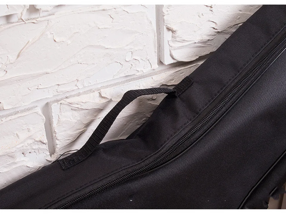 Close-up of the black ukulele bag handle and zipper.