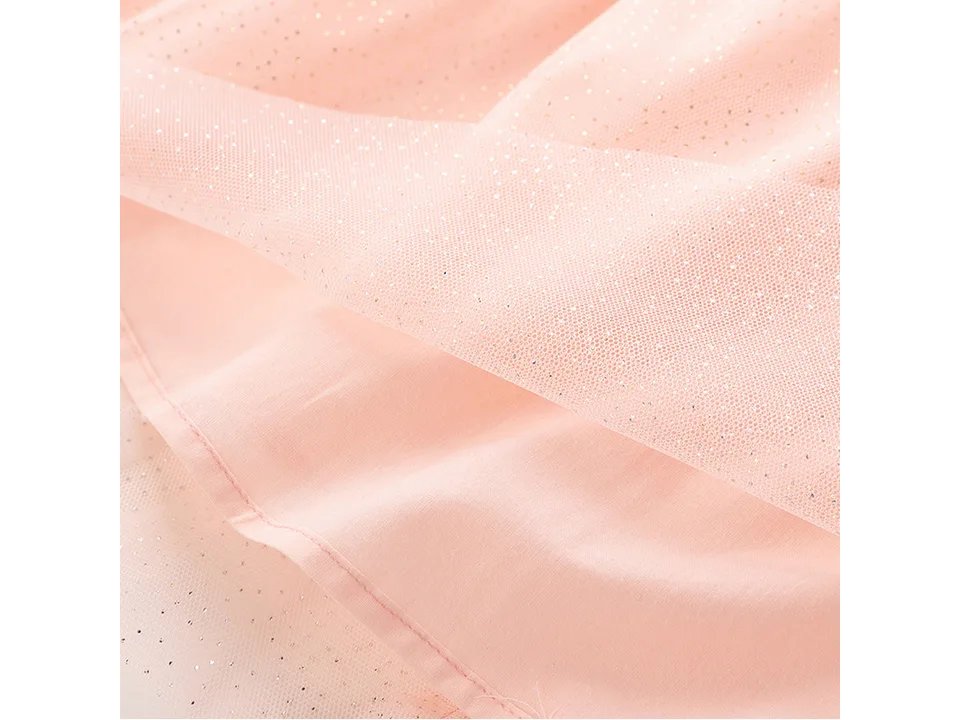 Close-up of the pink dress fabric showing the glittery net overlay and lining