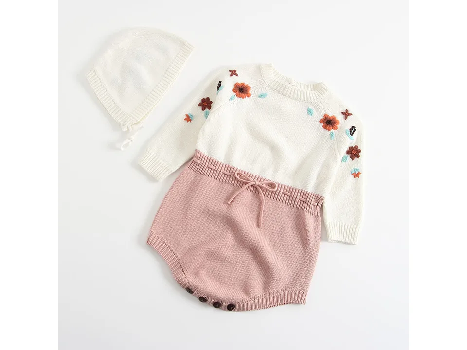 Embroidered knit baby romper and matching bonnet on a white background.