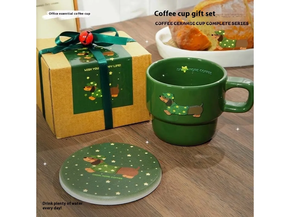 A green ceramic mug, a matching coaster, and a gift-wrapped box.