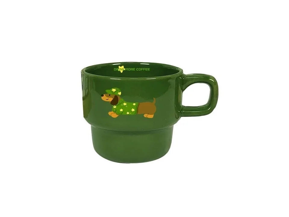 A single green ceramic coffee mug with a dachshund illustration.