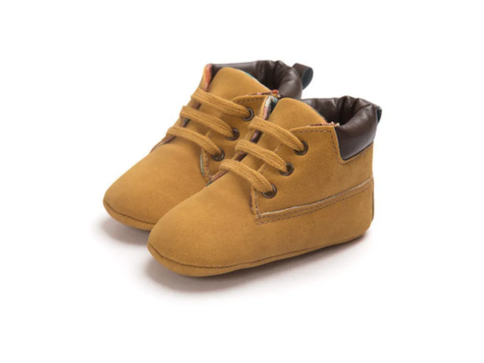 A pair of brown baby high-top shoes viewed from the side.