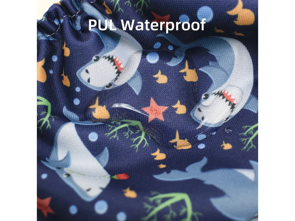 Close-up of the waterproof fabric with a shark pattern and water droplets on the surface.