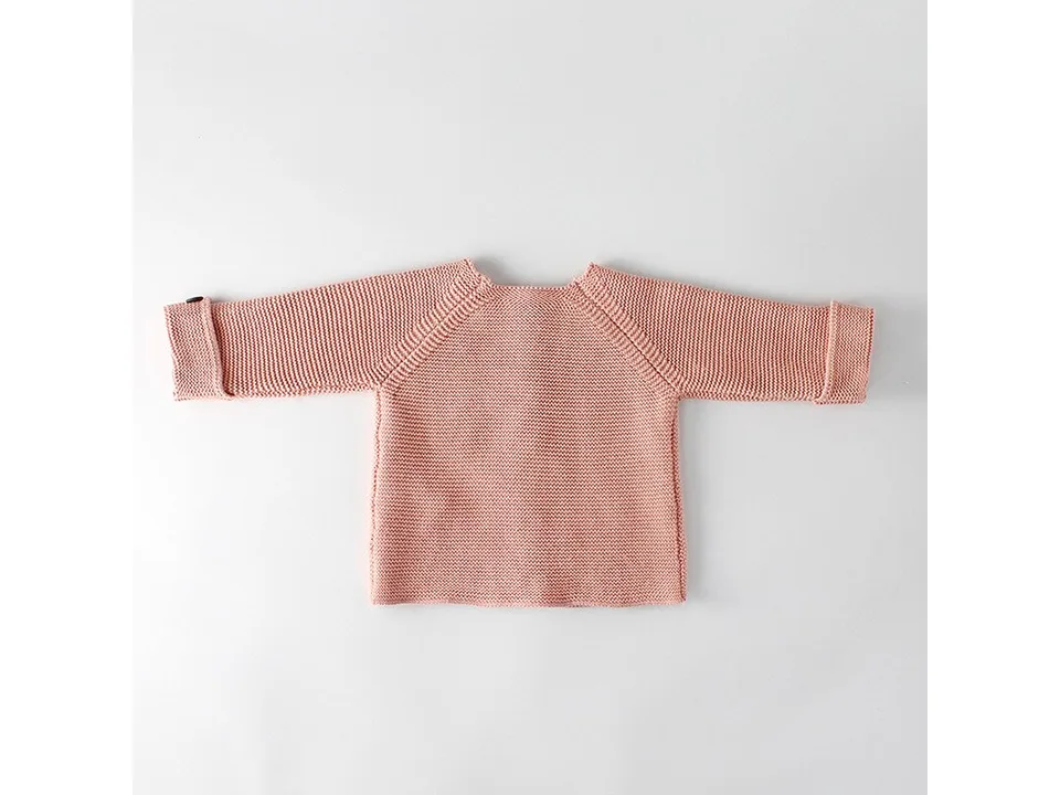 Back view of the pink knitted baby cardigan.