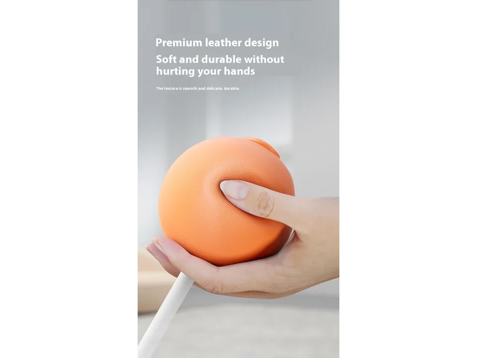 Close-up of a hand pressing into the soft, textured orange boxing ball.