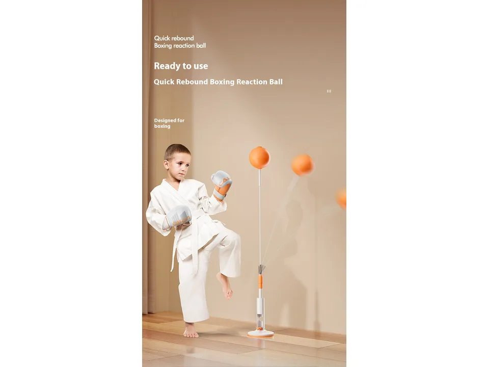 A child in a martial arts uniform practicing with the boxing reaction ball.