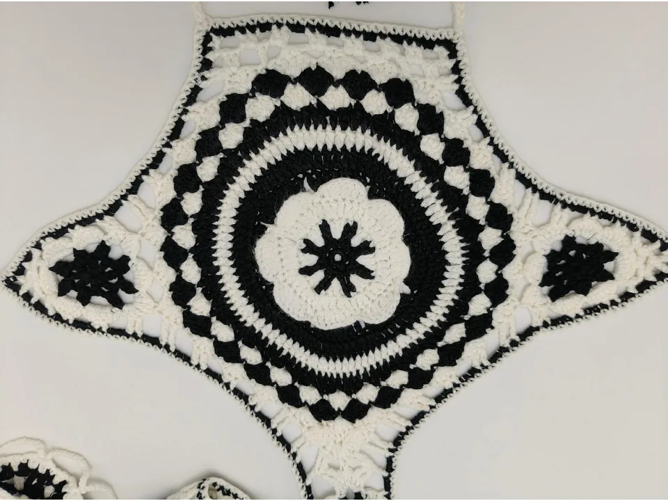 Close-up of the black and white crochet pattern on the bikini top.