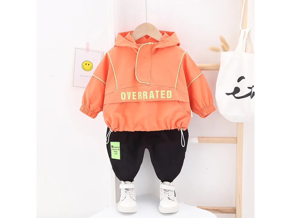 Orange hooded jacket and black pants set for children.