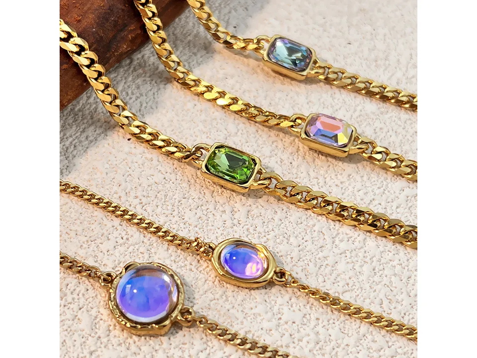A collection of gold chain bracelets with various colorful rectangular and round gemstones.