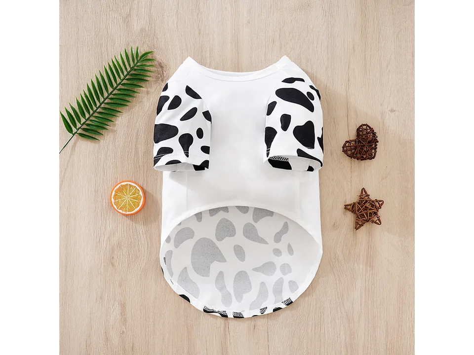 Back view of a white dog t-shirt with cow print sleeves.