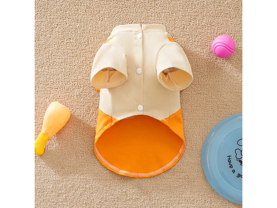 Back view of a beige and orange dog t-shirt with button closures.