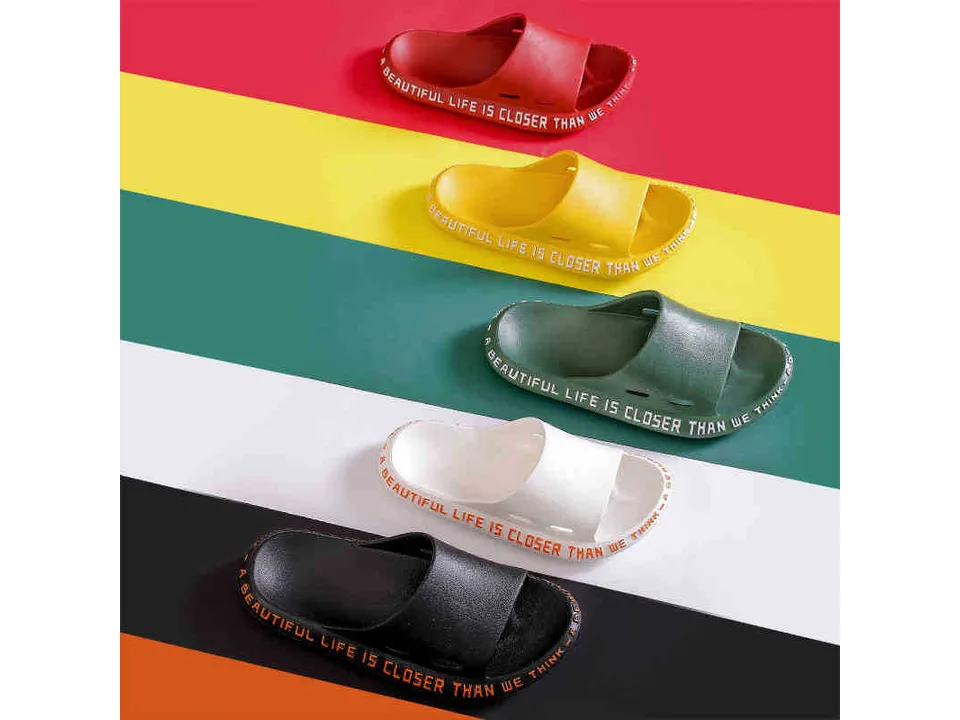 Five slide sandals in different colors arranged diagonally.