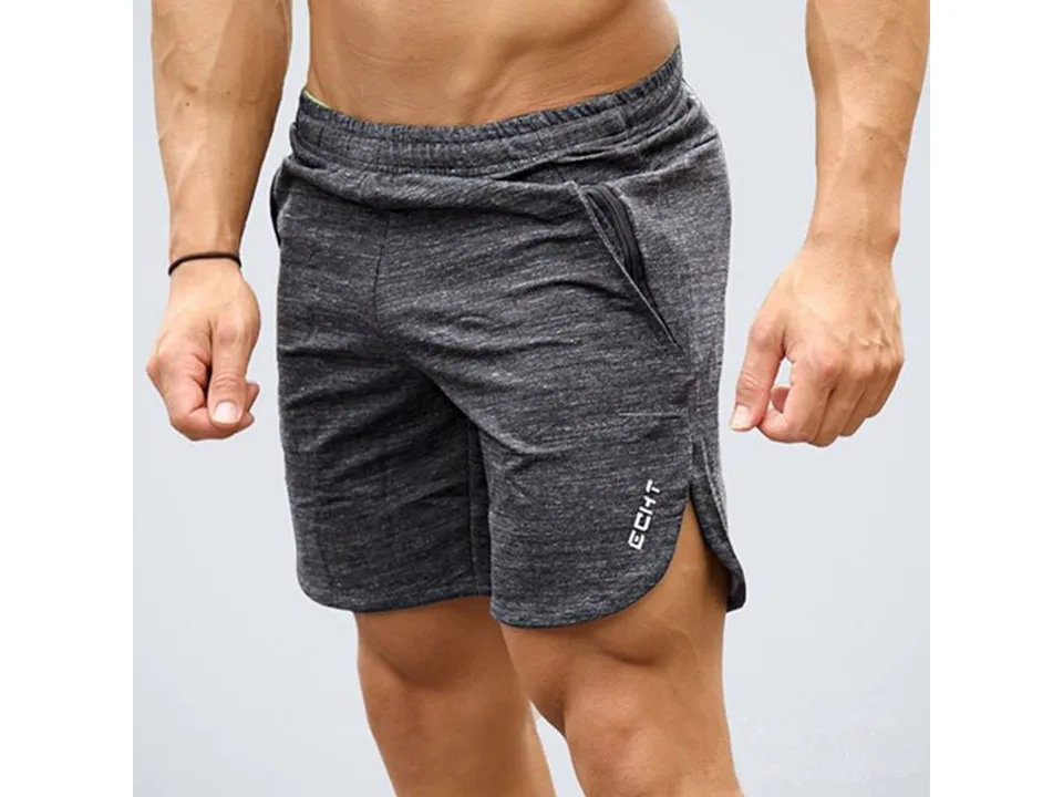 A man wearing dark grey athletic gym shorts.
